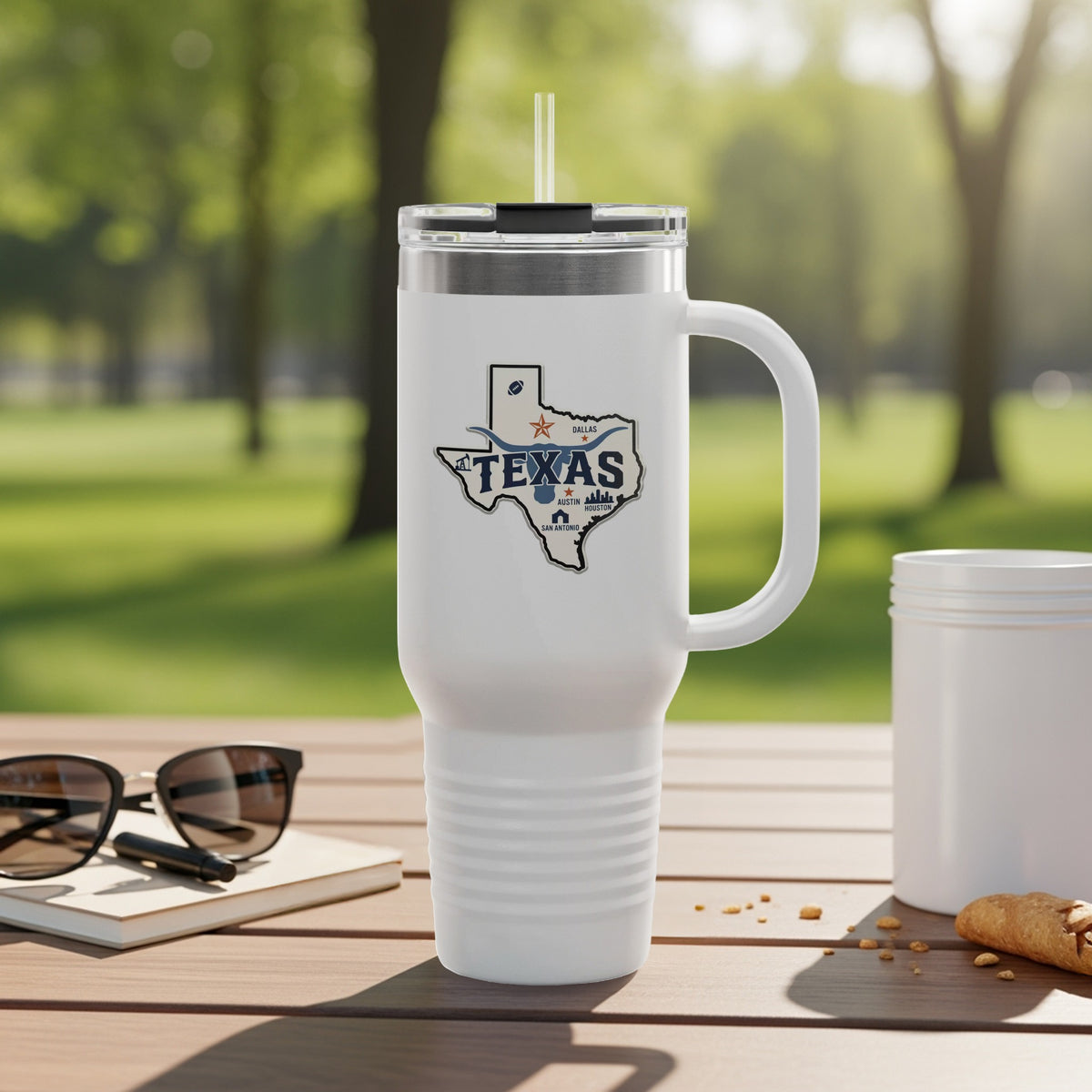 White tumbler with Texas graphic and handle, on a wooden table.