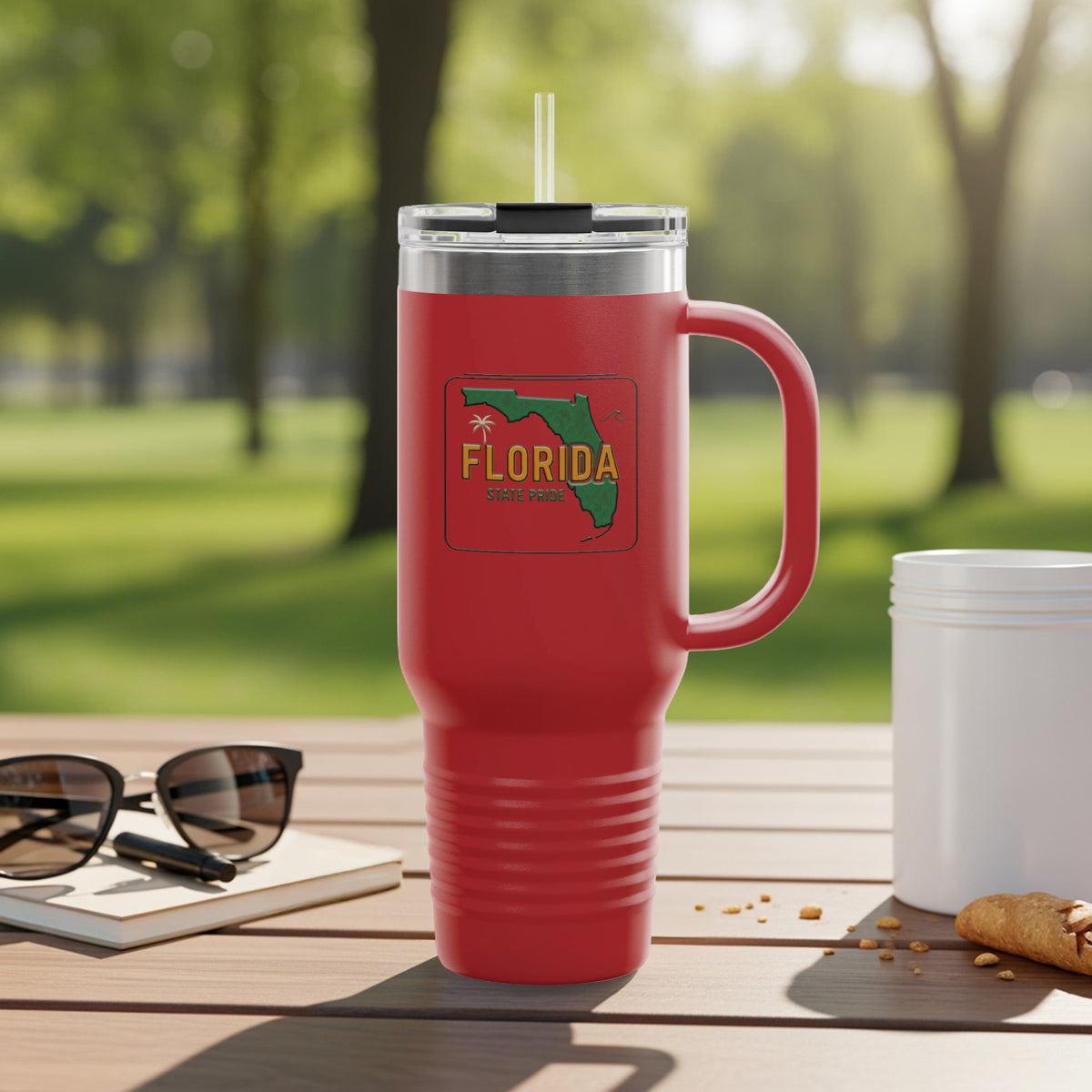 Red tumbler with Florida State Pride graphic on a wooden table.