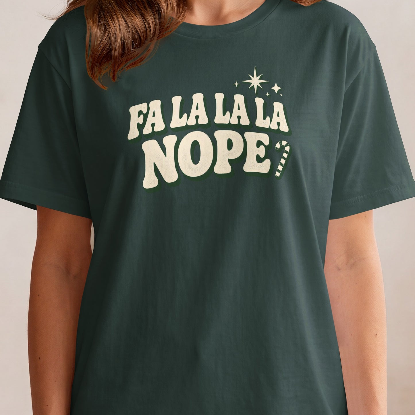 Green t-shirt with "FA LA LA LA NOPE?" text and candy cane graphic.