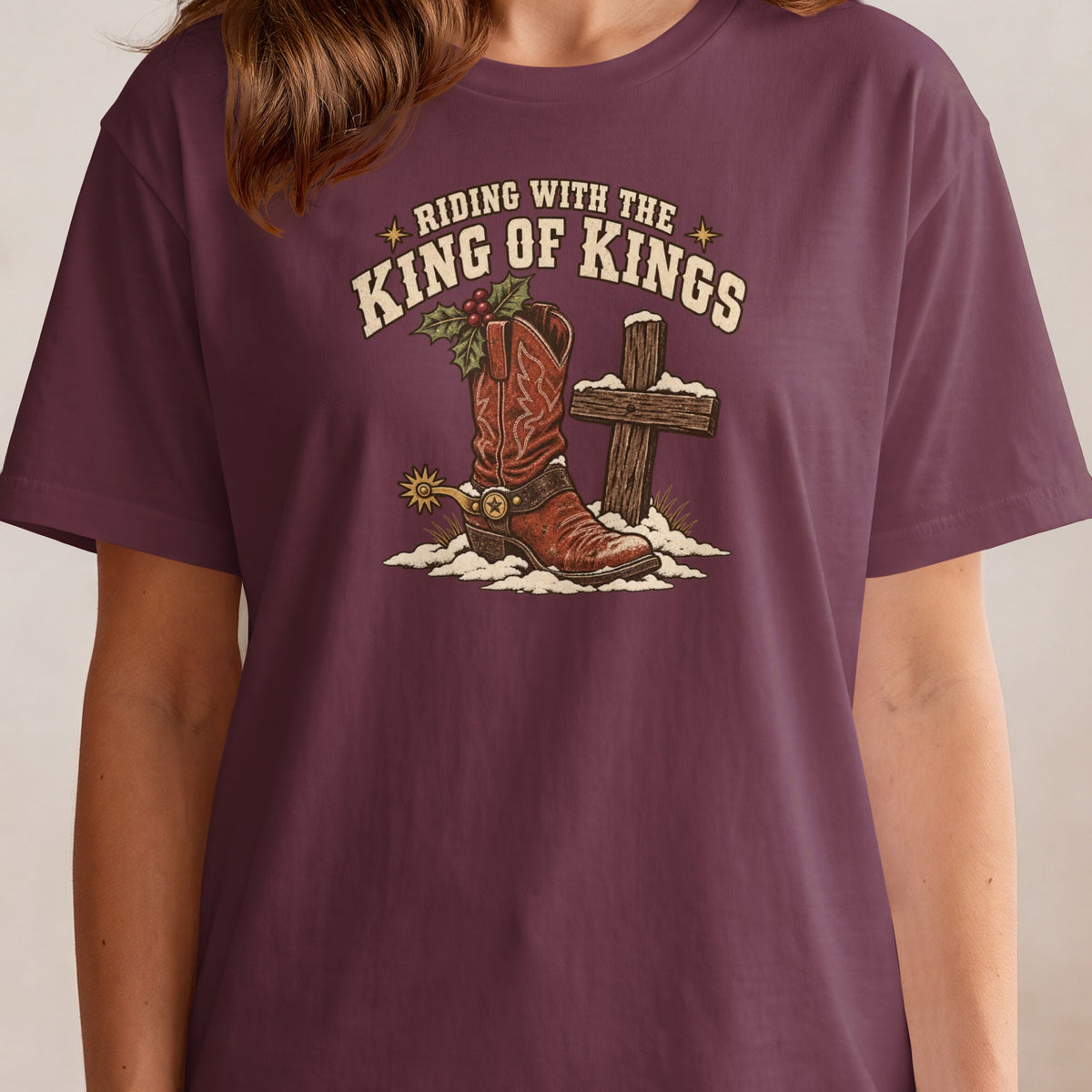 Riding with the King of Kings graphic with cowboy boot, holly, and cross in snow.