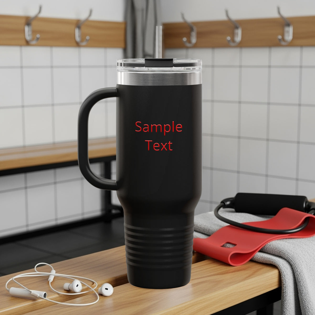 Black tumbler with handle and red text "Sample Text" on locker room bench.