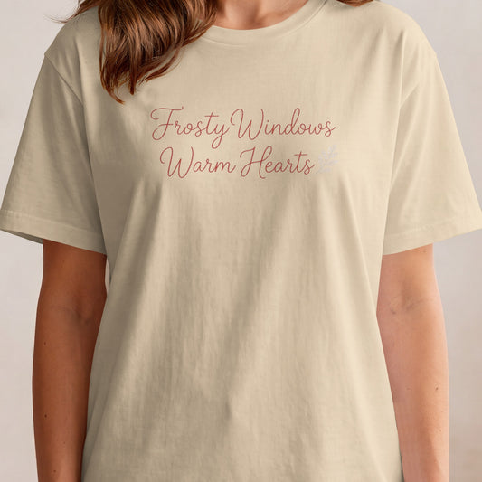 Cream t-shirt with "Frosty Windows Warm Hearts" text in a script font.