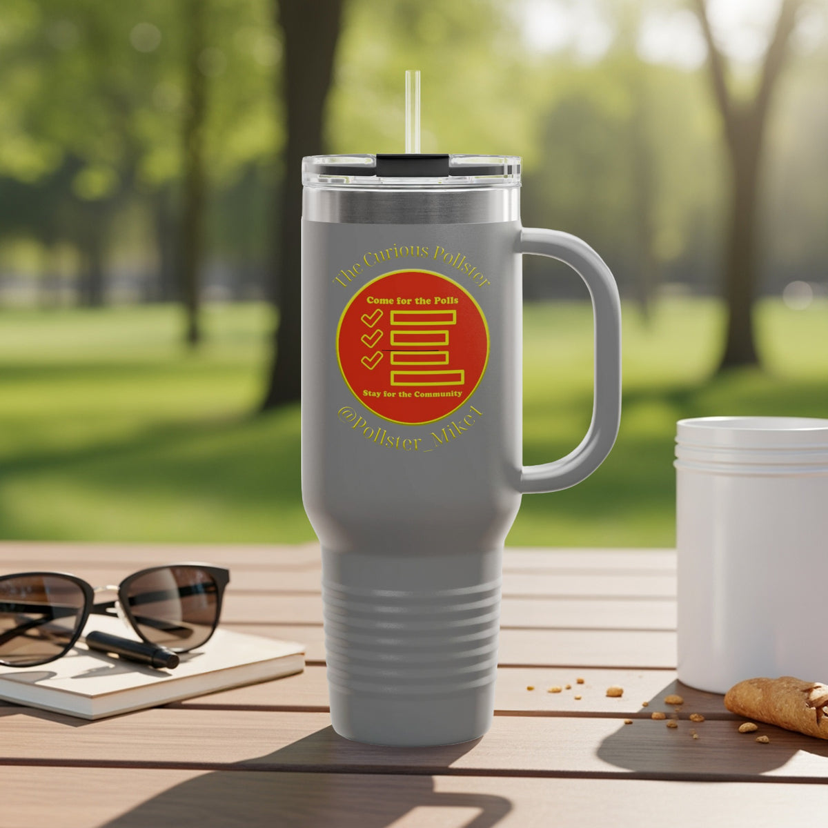 Gray travel tumbler with straw, featuring "The Curious Polster" logo with checkmarks.