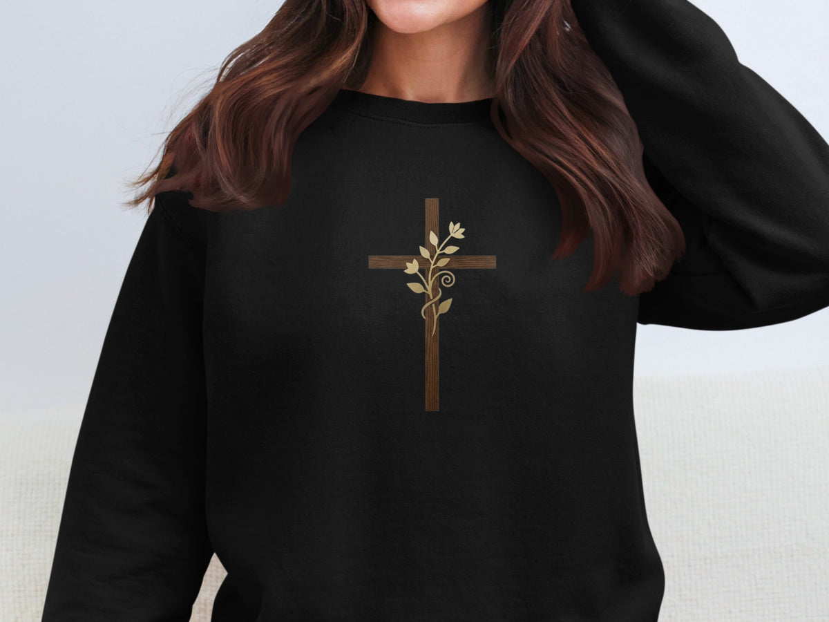 Black sweatshirt with a wooden cross and floral vine design.