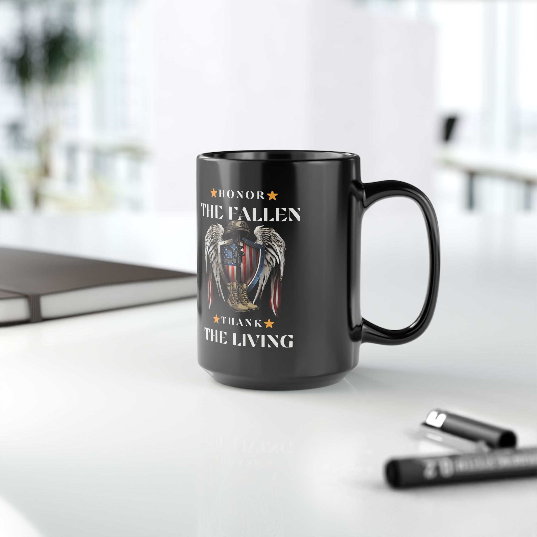 Black mug with 'Honor the Fallen, Thank the Living' text on a blurred background