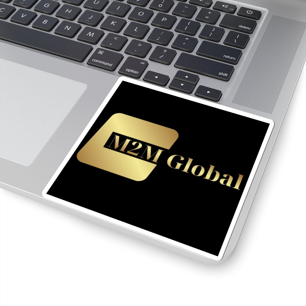 Gold 'M2M Global' logo on a gray background