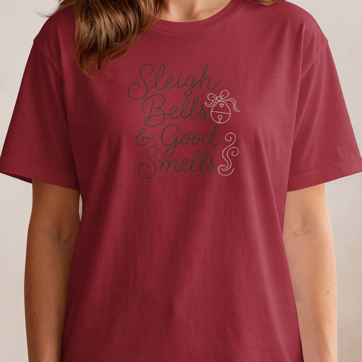 Red t-shirt with "Sleigh Bells & Good Smells" text and a bell graphic.