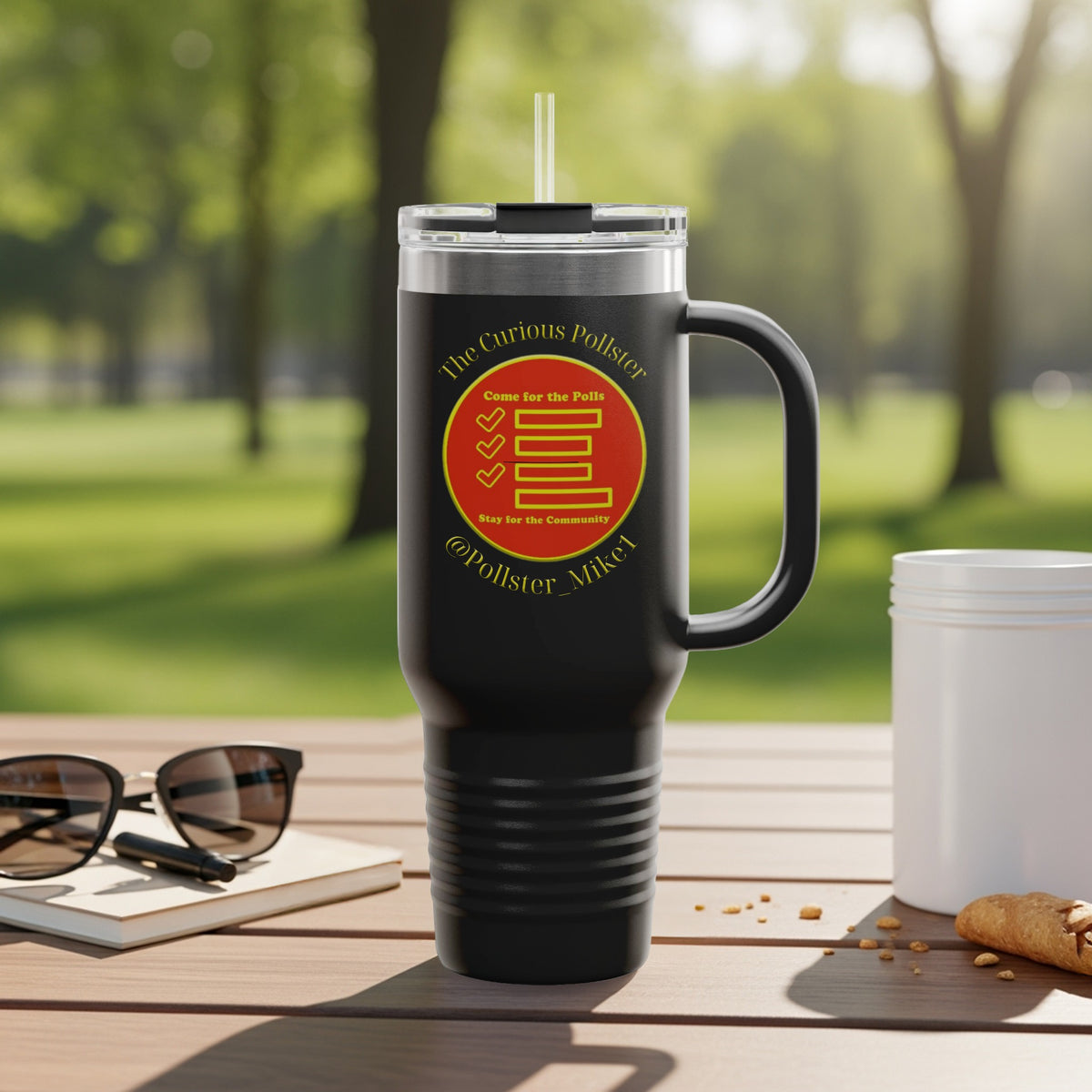 Black travel tumbler with "The Curious Pollster" logo and handle on a wooden table.
