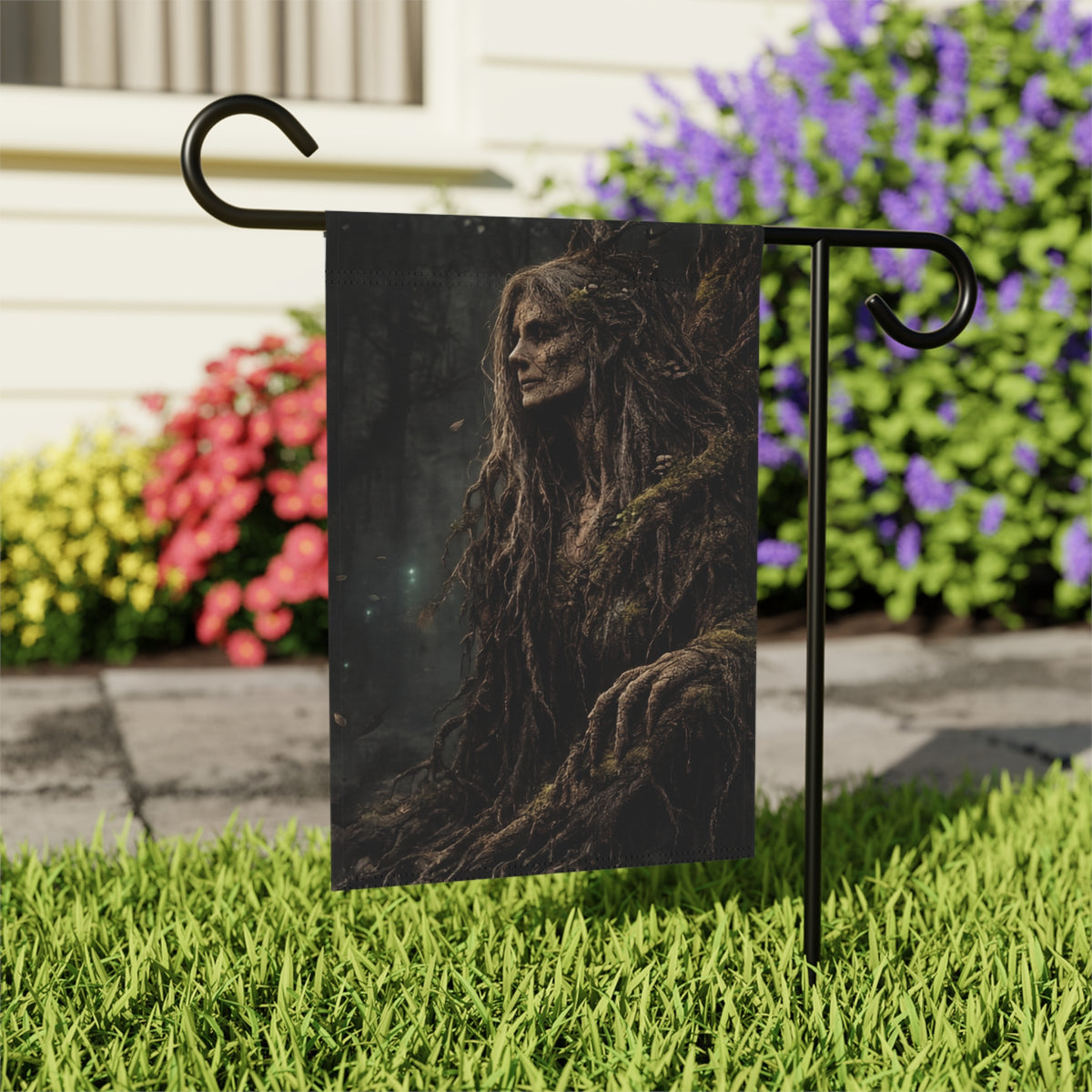 Garden flag with a dark forest scene featuring a gnarled, root-like figure.