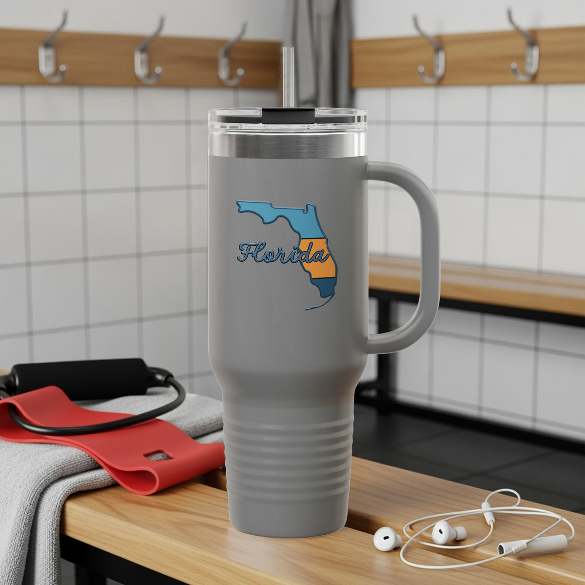 Gray tumbler with Florida outline and "Florida" text, sitting on a bench.