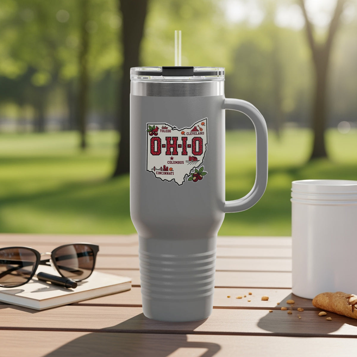 Travel mug with Ohio map graphic and city names.