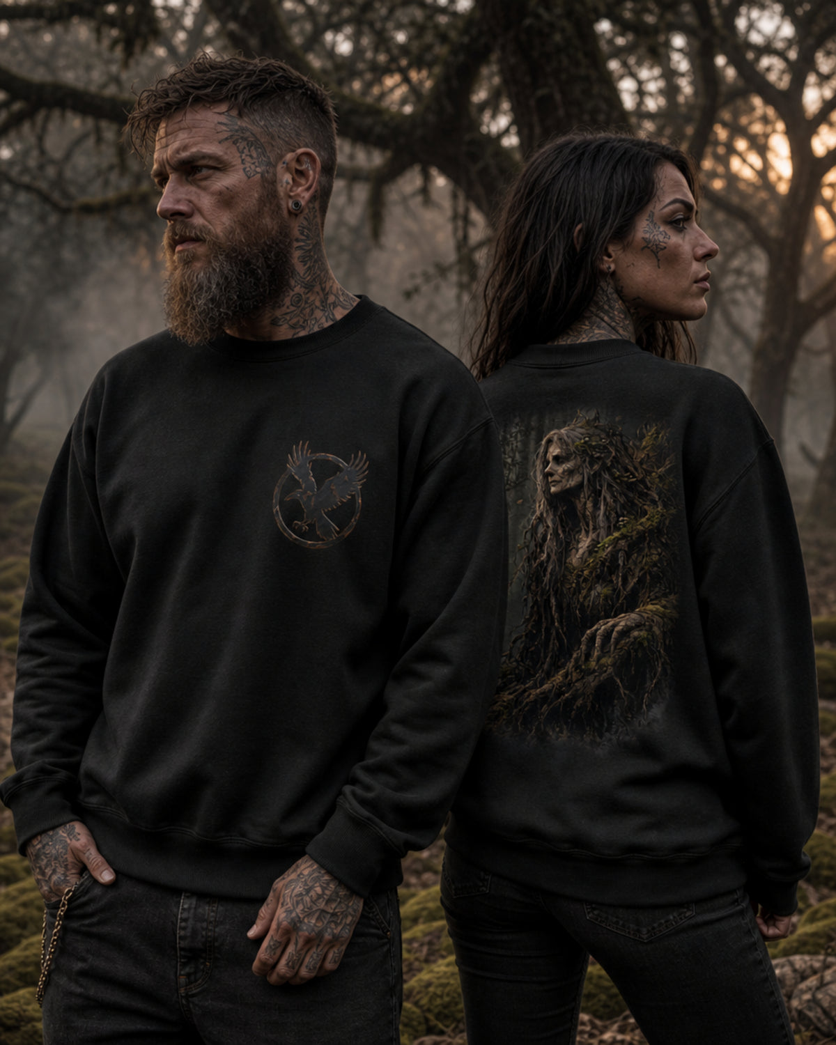 Two models wearing black Dark Folklore Series Forest Witch crewneck sweatshirts, front view, with the raven in flight emblem on the chest.