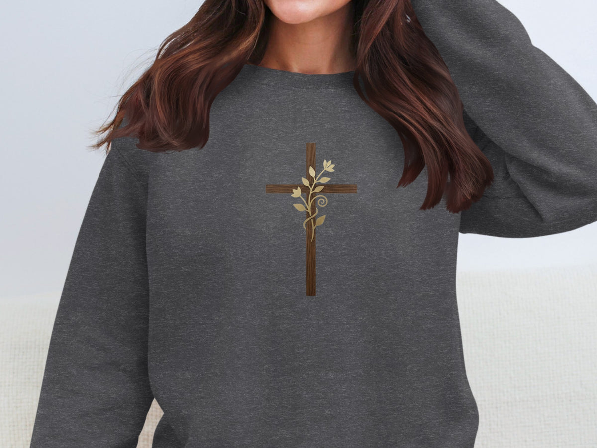 Dark gray crewneck sweatshirt with embroidered brown cross and gold leaf design.