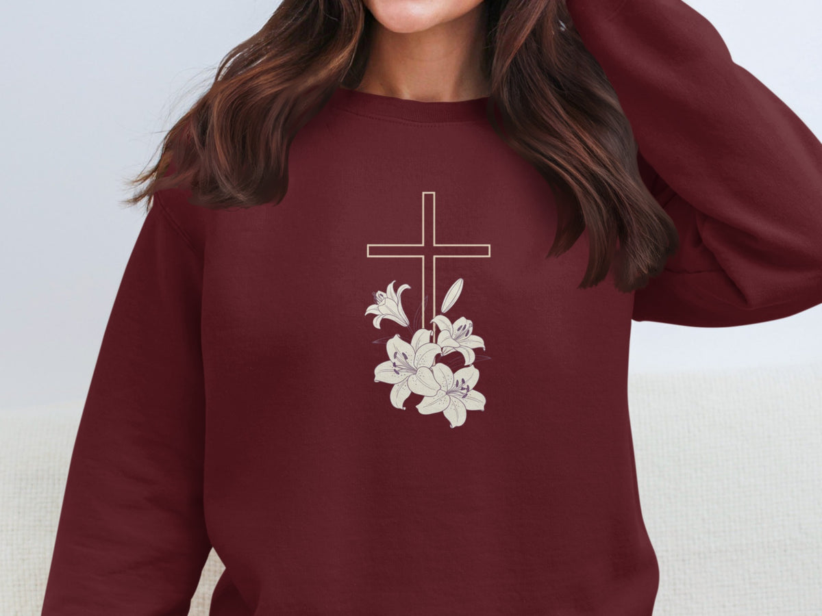 Maroon sweatshirt with a line drawing of a cross and lilies.