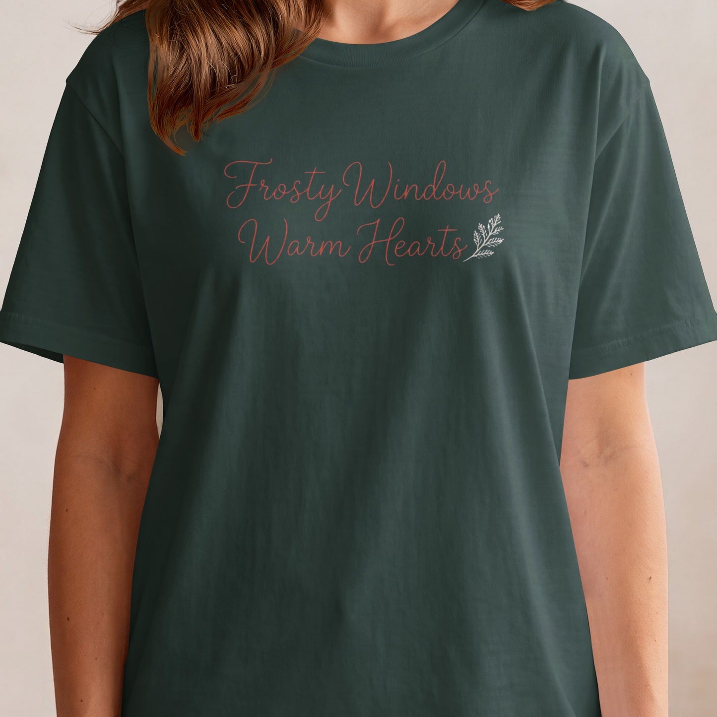 Dark green t-shirt with "Frosty Windows Warm Hearts" text and a small sprig.