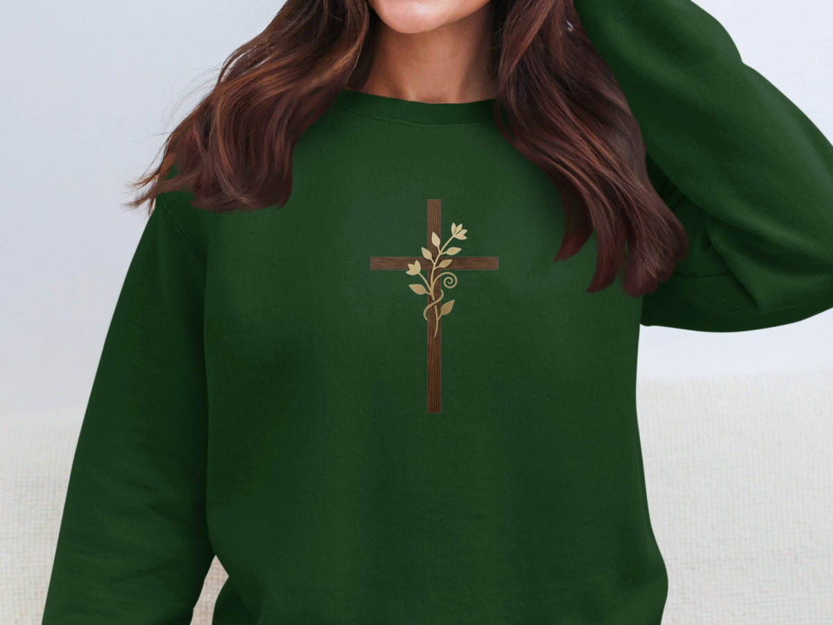 Dark green crewneck sweatshirt with a subtle brown wooden cross and vine design.
