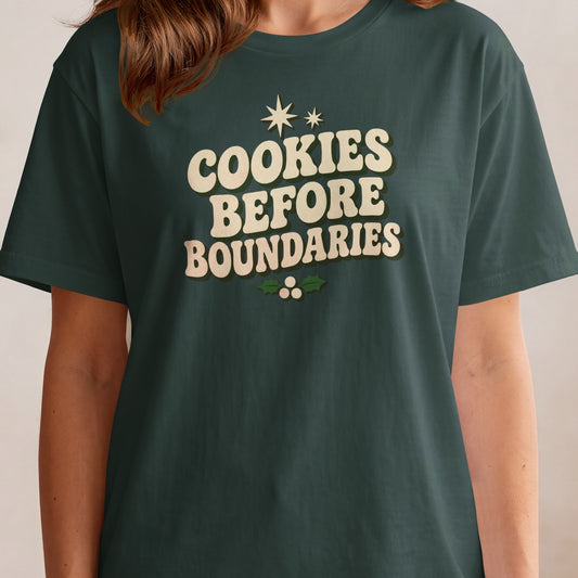 Dark green t-shirt with "Cookies Before Boundaries" text and holly.