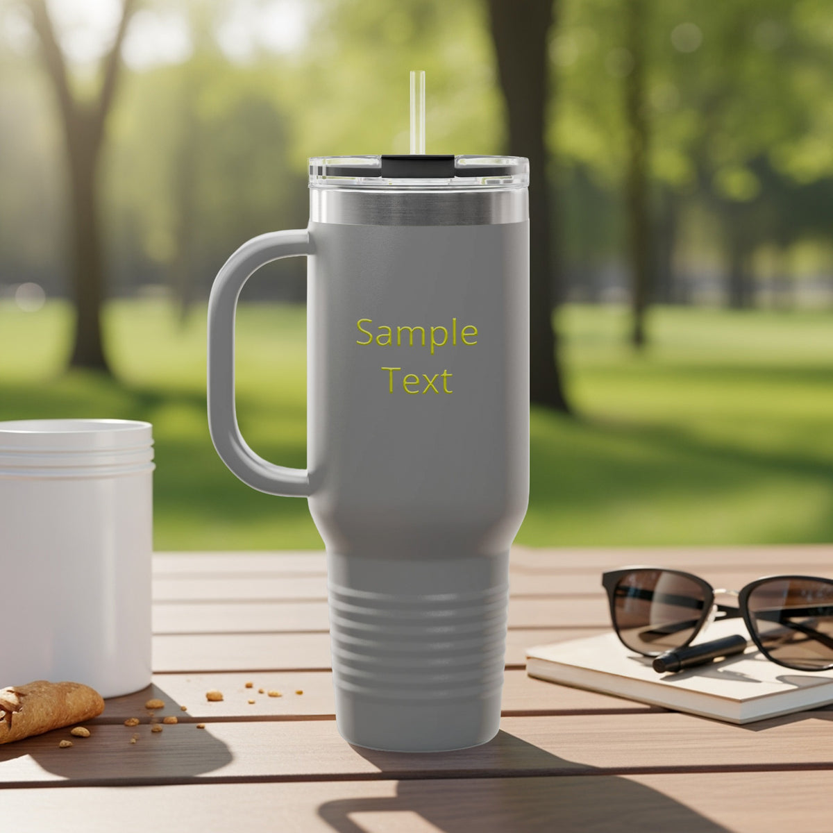 Gray tumbler with handle and straw, "Sample Text" in yellow.