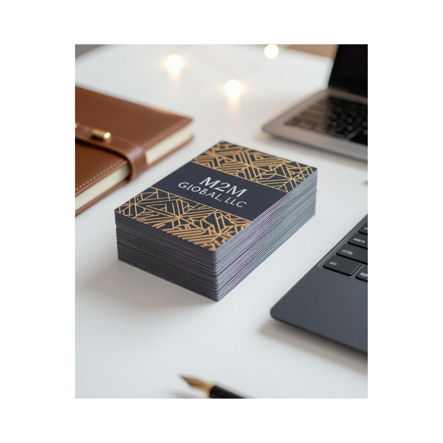 Modern office desk with custom business cards and professional tools, branded with M2M Global, LLC
