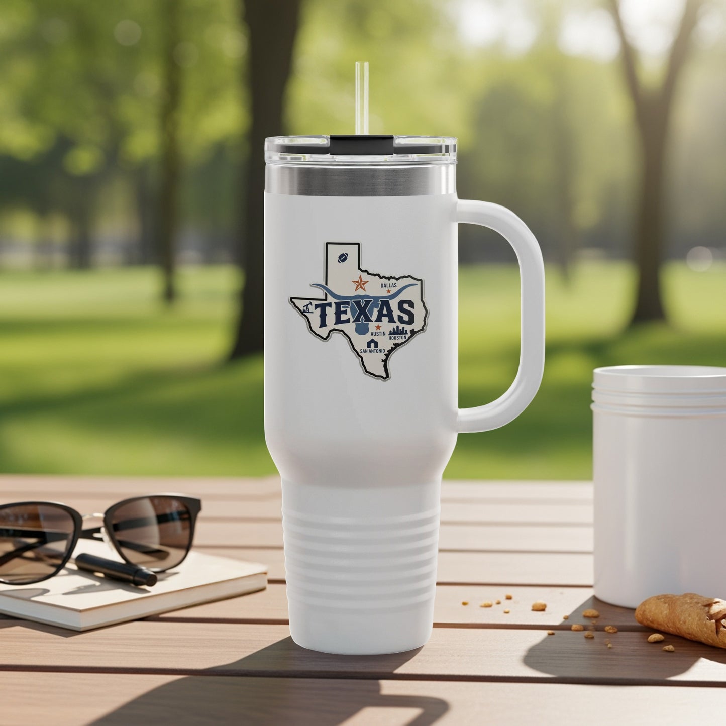 White tumbler with Texas graphic and handle, on a wooden table.