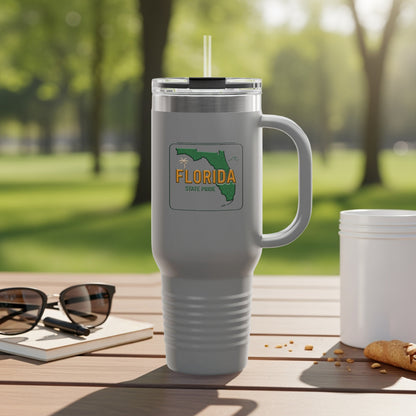 Travel tumbler with Florida Sunshine State logo, outdoors.