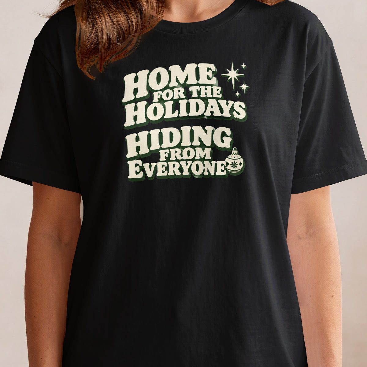 Black t-shirt with "Home For The Holidays Hiding From Everyone" text and holiday graphics.