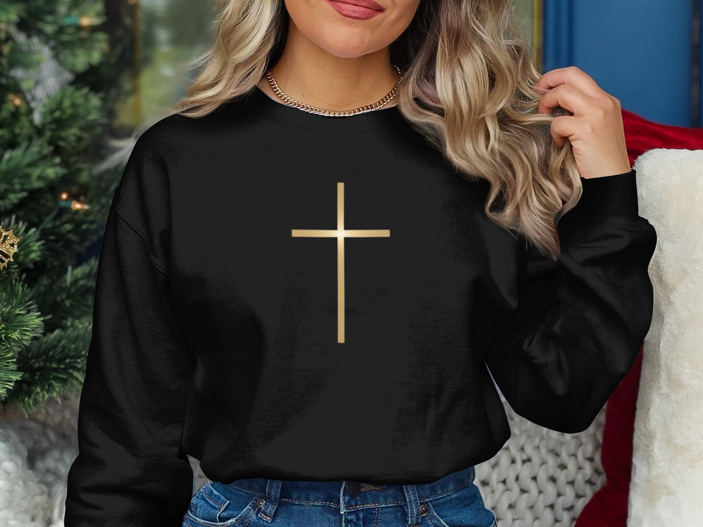 Black sweatshirt with a gold cross graphic on the chest.