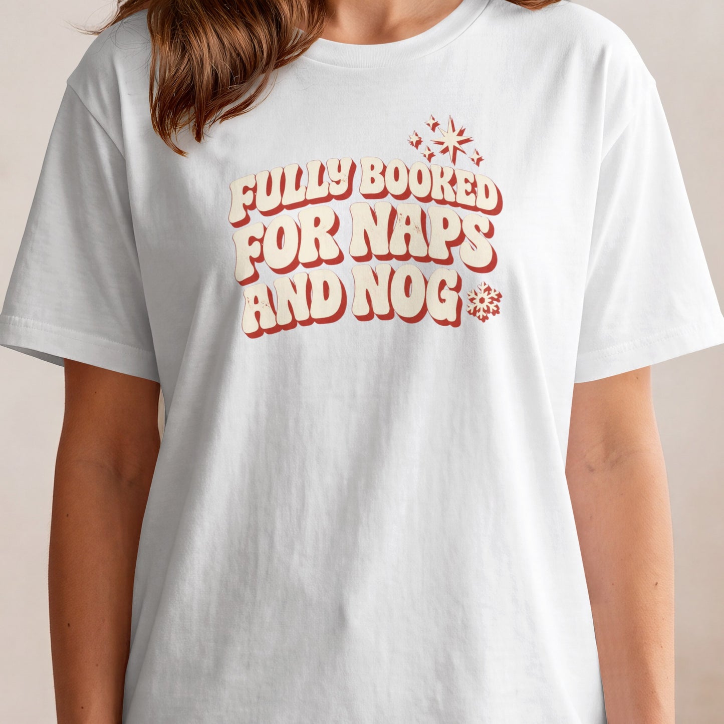 White t-shirt with red and cream text reading "Fully Booked for Naps and Nog"
