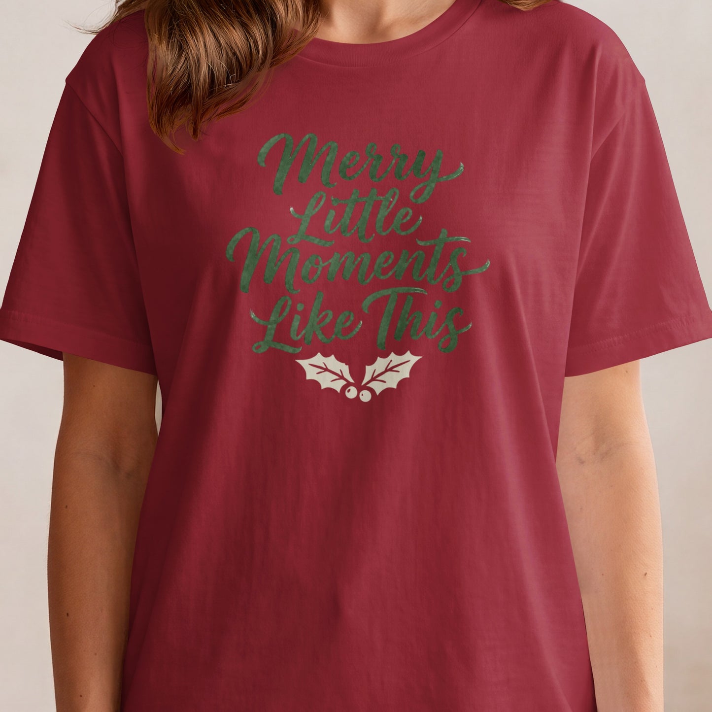 Maroon t-shirt with green text "Merry Little Moments Like This" and holly.