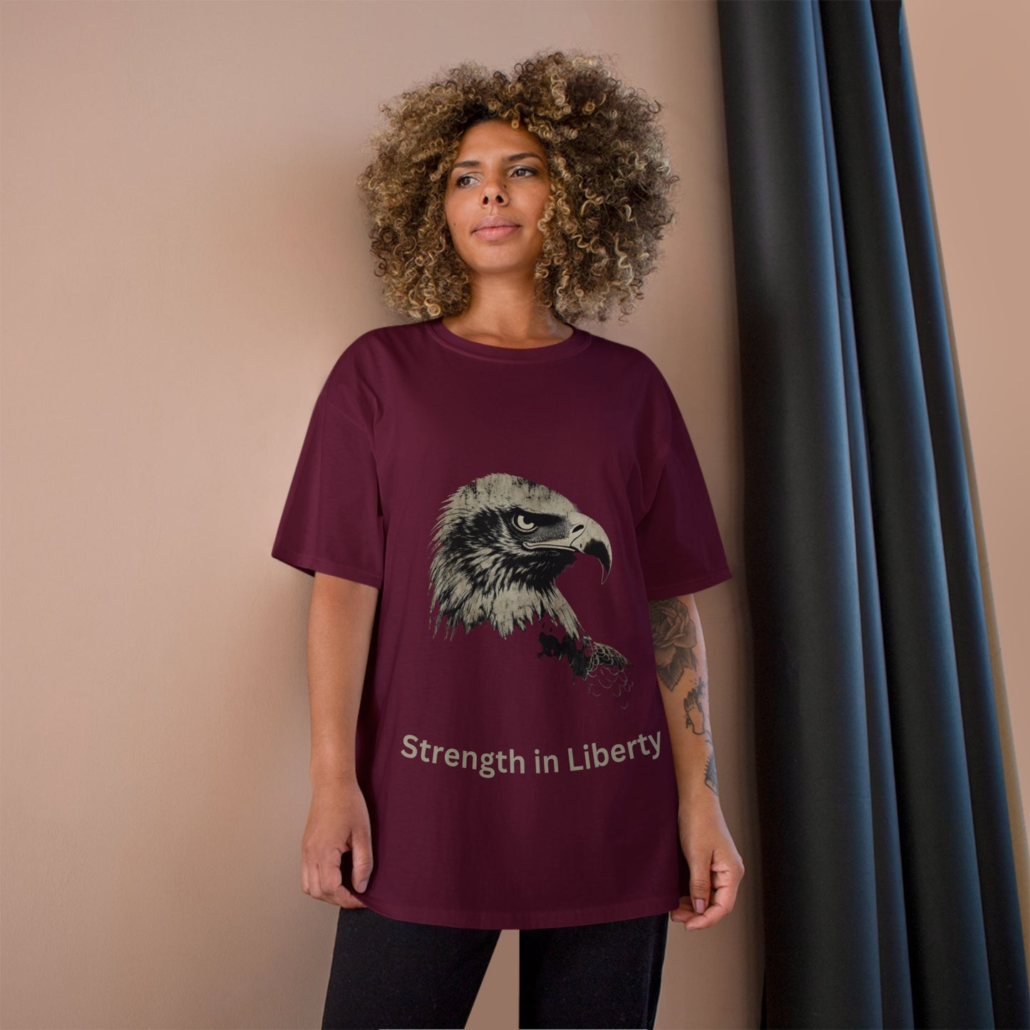 Strength in Liberty text below an eagle head on a Champion Tee