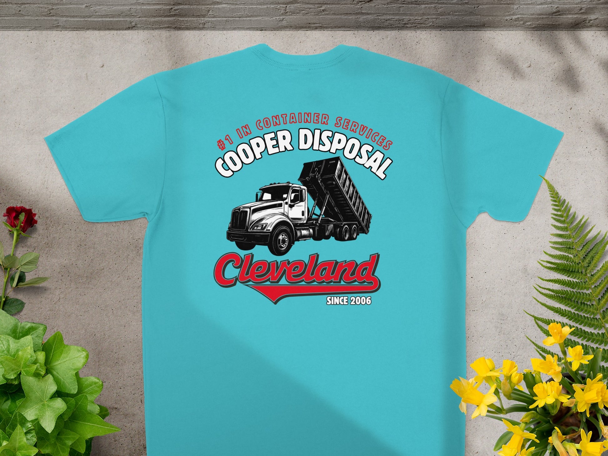 Teal t-shirt with Cooper Disposal truck graphic and red arrow.