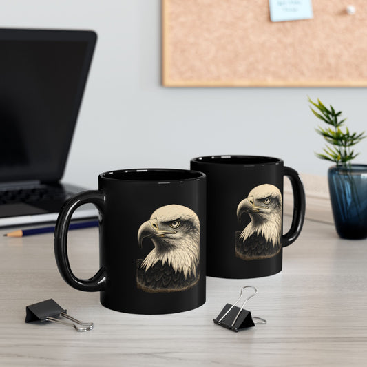 Two black mugs with an eagle's head design displayed on a desk.