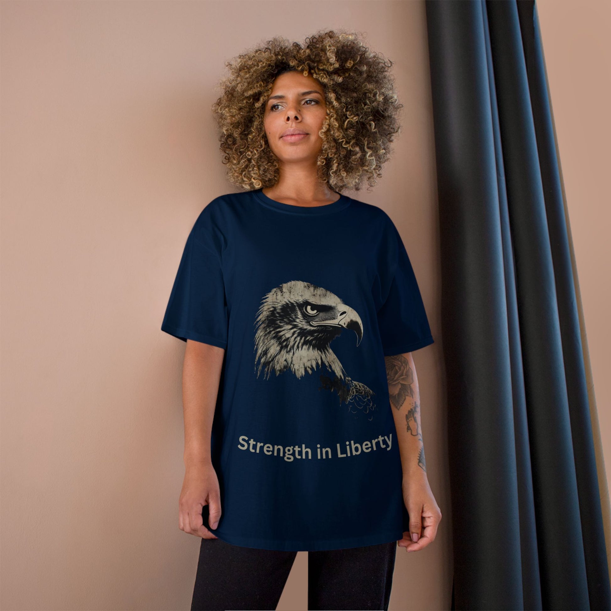 Strength in Liberty text below an eagle head on a Champion Tee