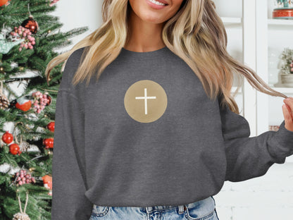 Dark gray sweatshirt with a gold circle containing a white cross design.