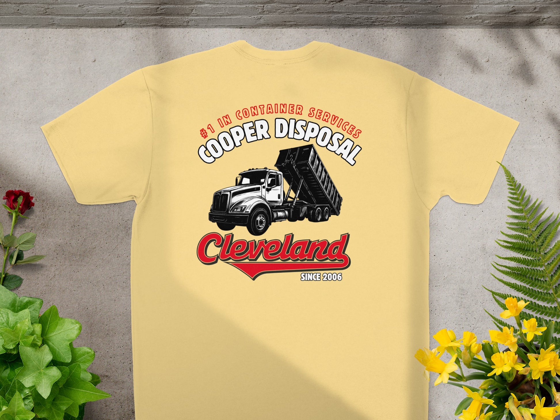 Yellow t-shirt with Cooper Disposal logo featuring a dump truck and "Cleveland Since 2006".