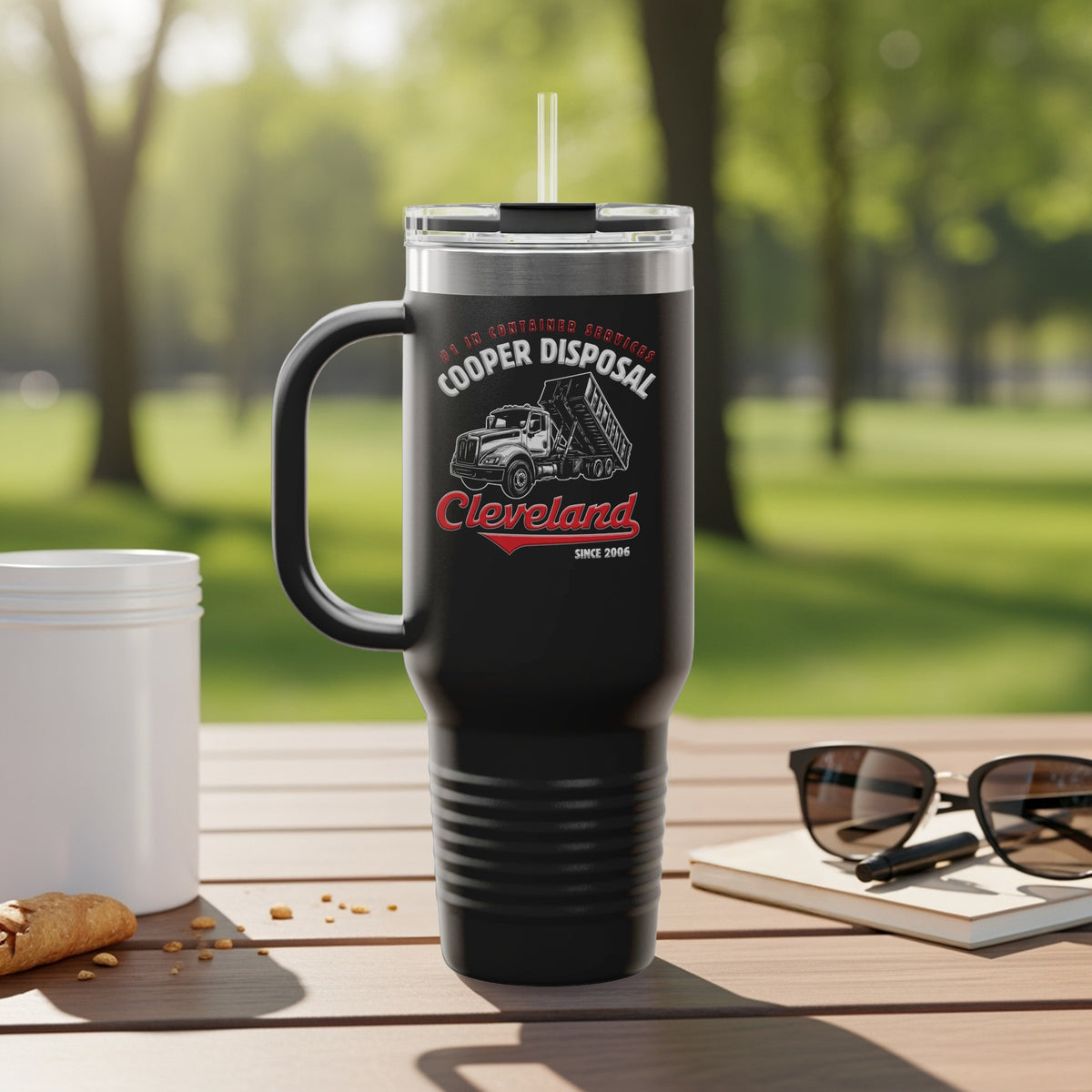 Black travel tumbler with Cooper Disposal logo, dump truck graphic, and Cleveland text.