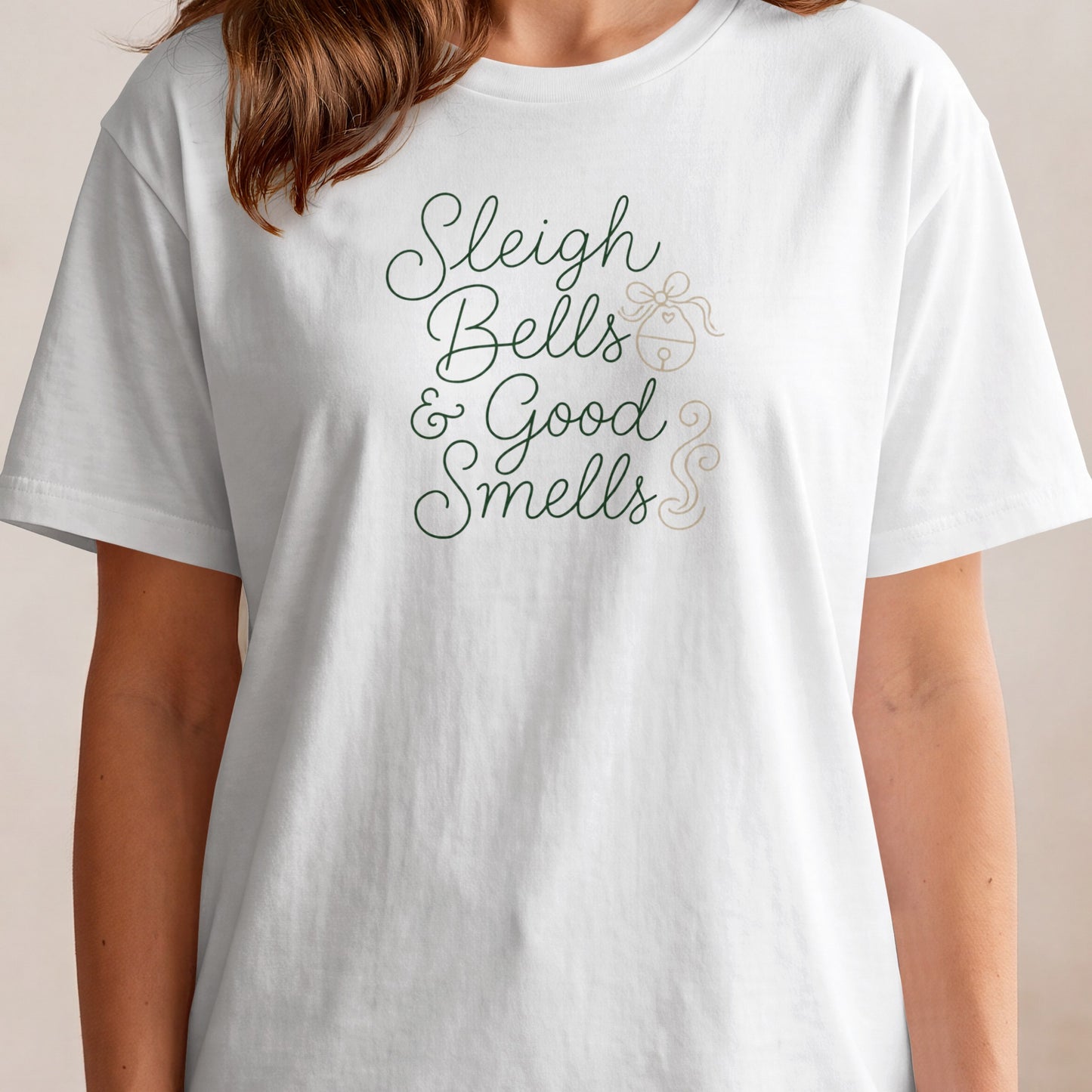 White t-shirt with "Sleigh Bells & Good Smells" text and a bell graphic.