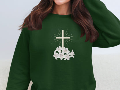 Green sweatshirt with white lilies and a cross design.