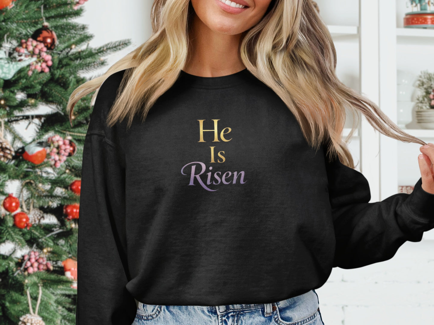 Black sweatshirt with "He Is Risen" text in purple and gold.