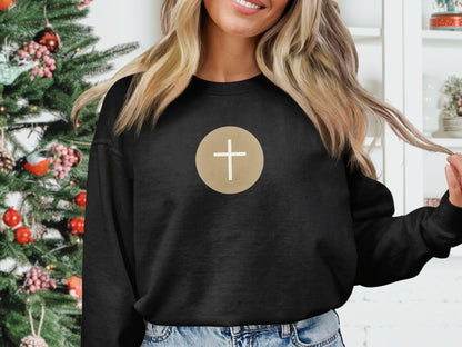 Black crewneck sweatshirt with a gold-outlined cross graphic on the chest.