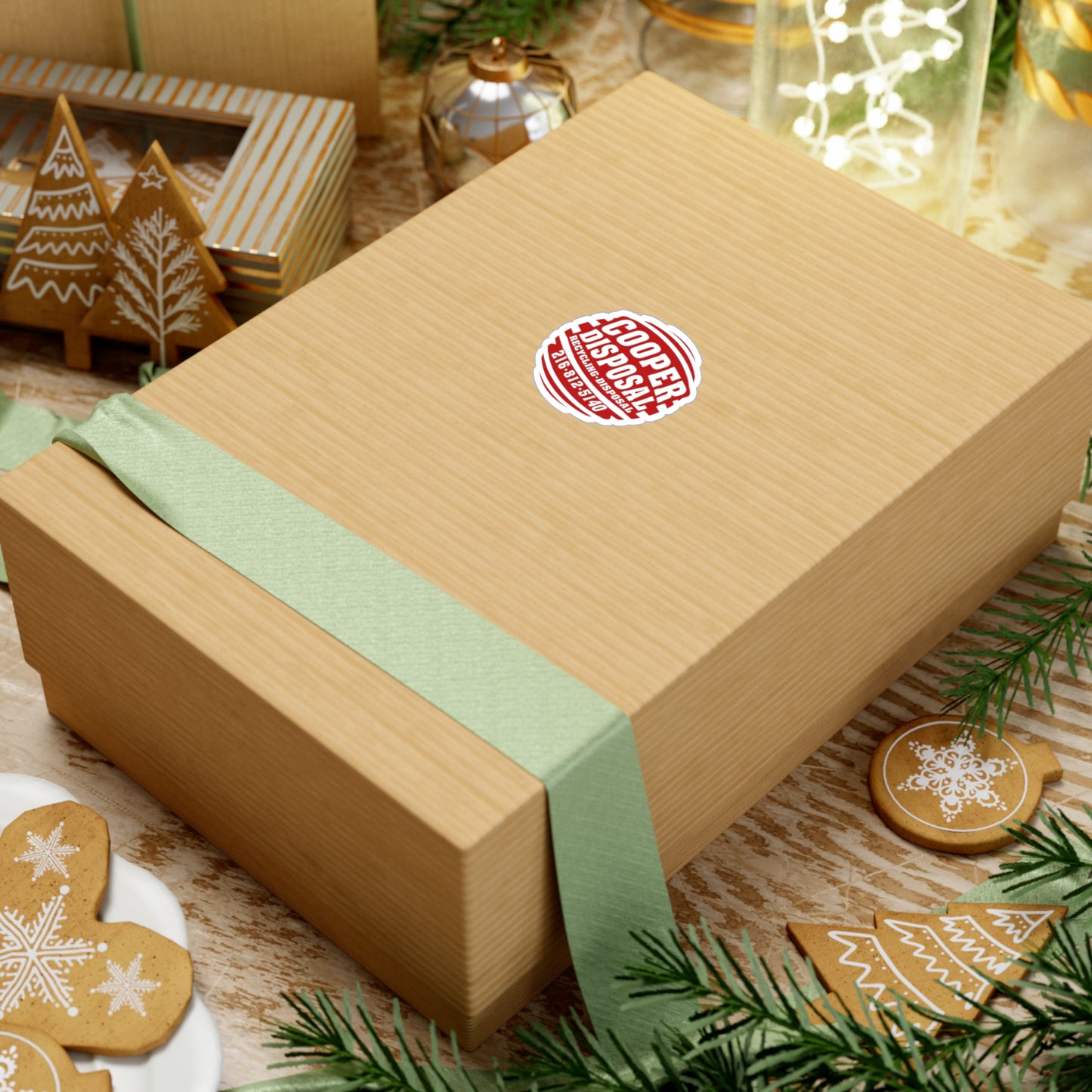 Brown gift box with green ribbon and Cooper Disposal sticker.