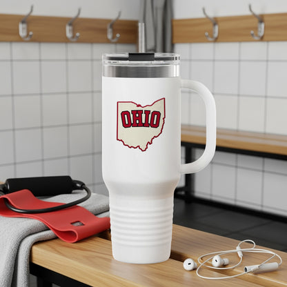White tumbler with Ohio outline graphic, gym background.