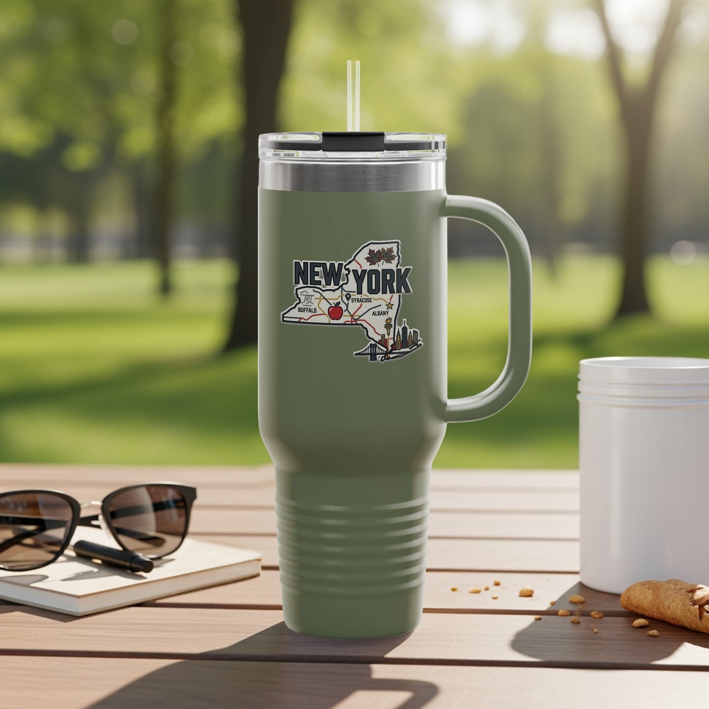 Olive green travel tumbler with New York state map graphic and handle.
