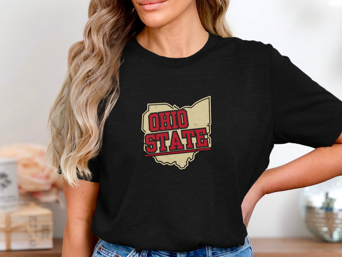 Ohio State outline with distressed text on a black t-shirt.