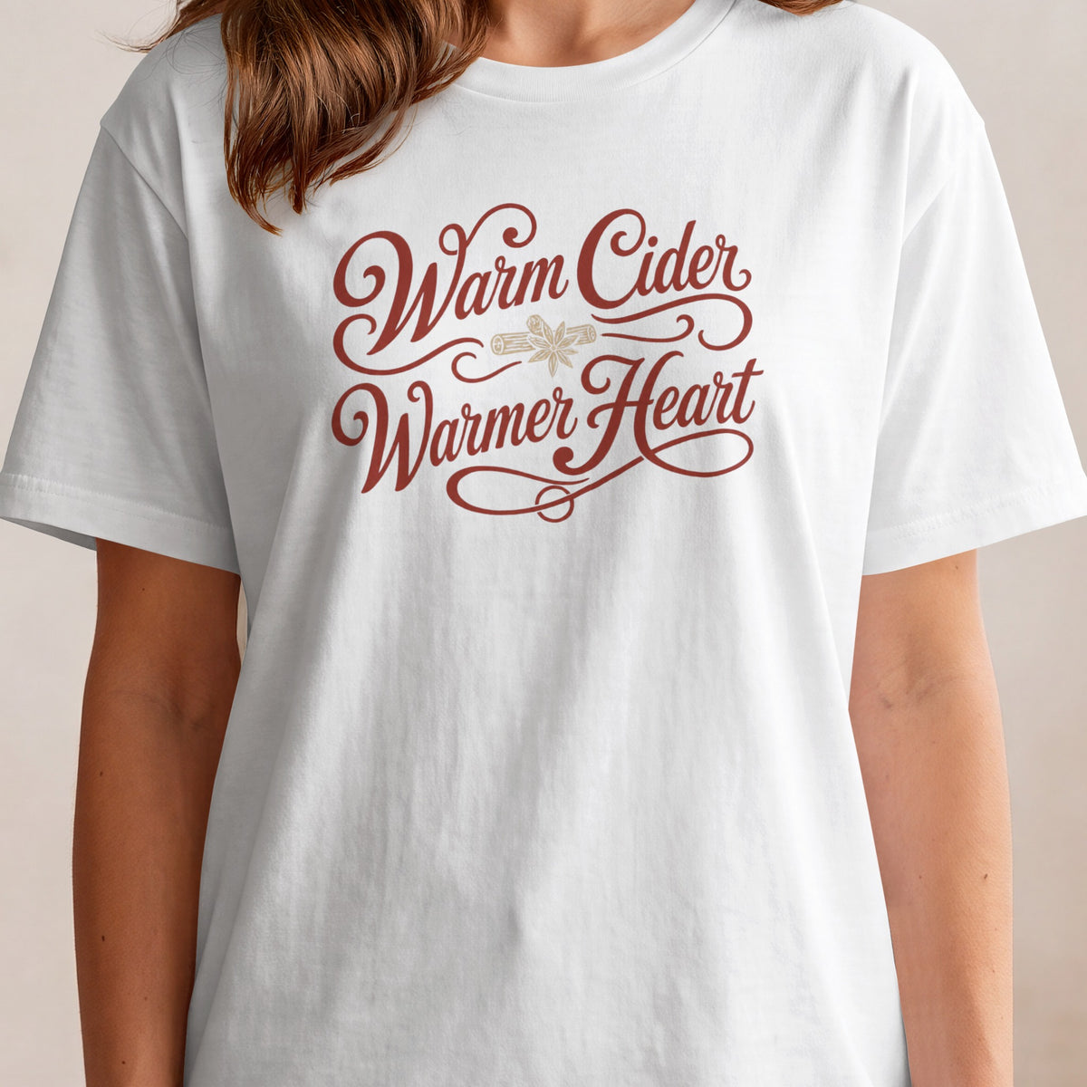White t-shirt with "Warm Cider Warmer Heart" text and cinnamon stick graphic.