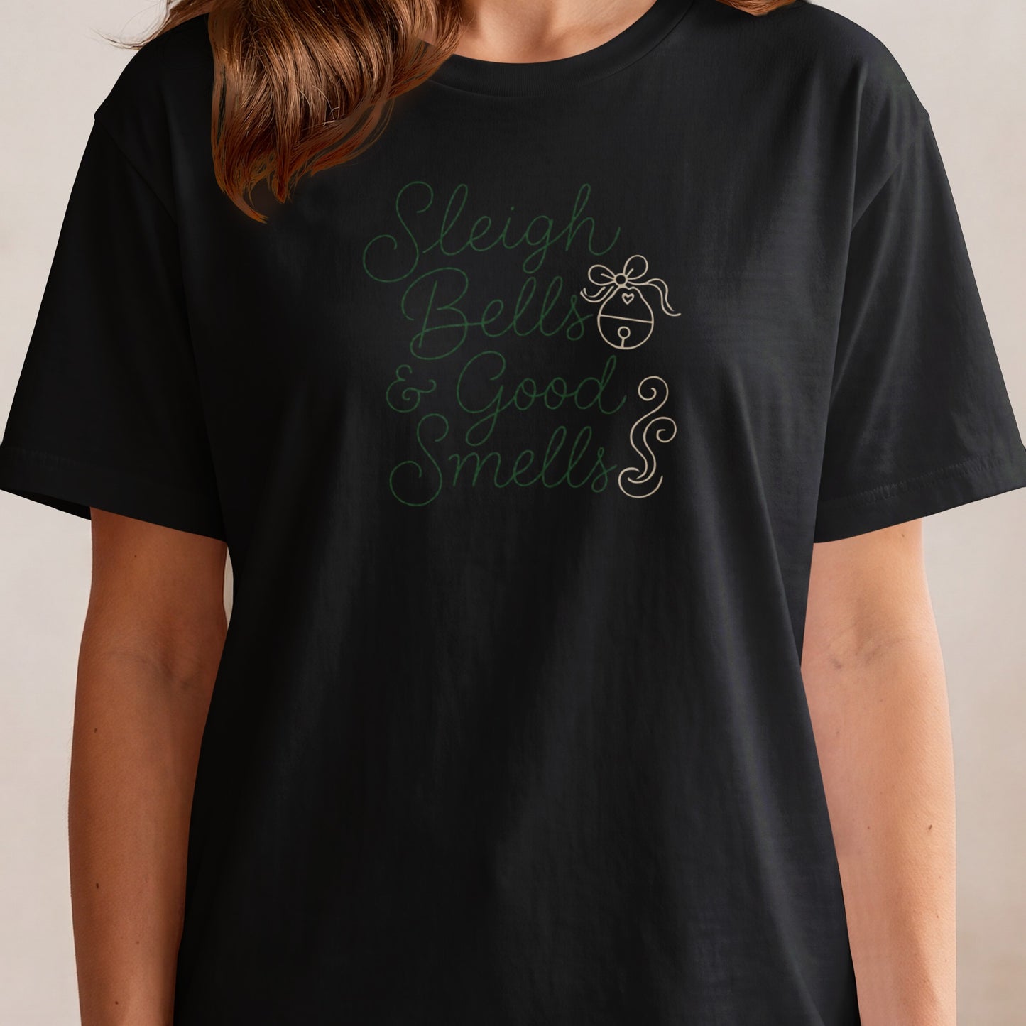 Black t-shirt with green text "Sleigh Bells & Good Smells" and a bell graphic.