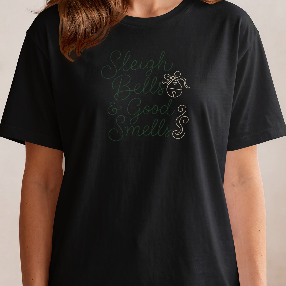 Black t-shirt with green text "Sleigh Bells & Good Smells" and a bell graphic.