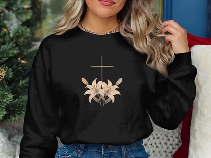 Black crewneck sweatshirt with a gold cross and lilies graphic.