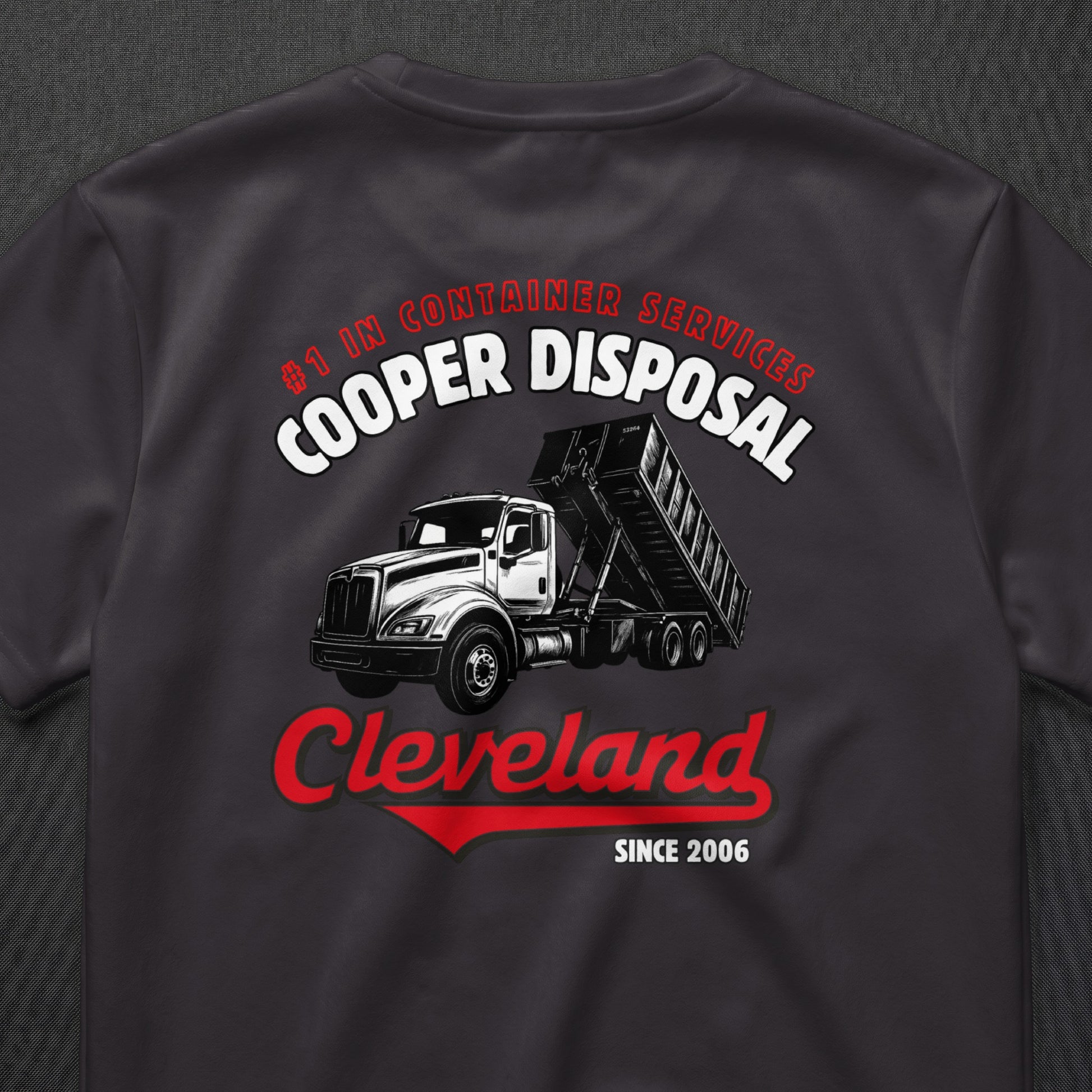 Dark t-shirt with white and red graphic of a dump truck and "Cleveland" text.