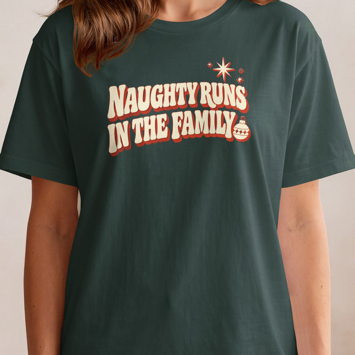 Dark green t-shirt with text "NAUGHTY RUNS IN THE FAMILY".